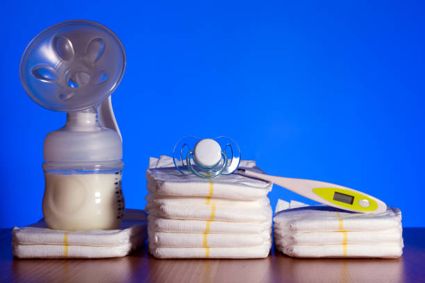 istock breast pump and nappies and thermometer with a pacifier on a blue background 1188680727