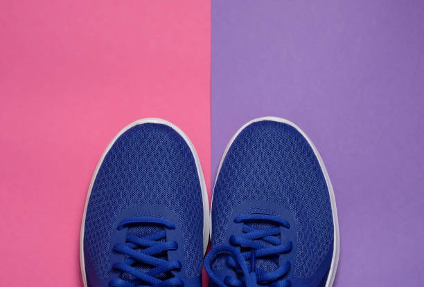 istock Sport sneakers on pink purple background with copy space for text. Sport objects background. Sports concept 1188681496
