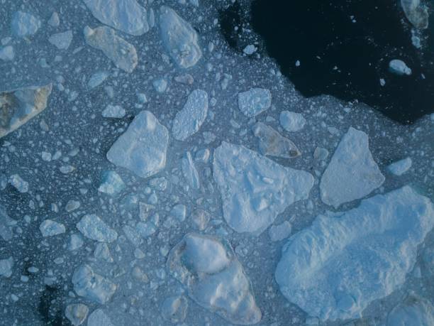 istock Icebergs drone aerial image top view - Climate Change and Global Warming. Icebergs from melting glacier in icefjord in Ilulissat, Greenland. Arctic nature ice landscape in Unesco World Heritage Site. 1188683116