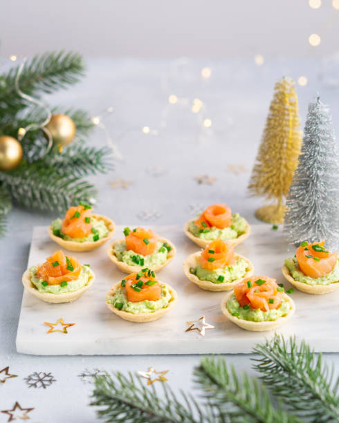 canapes com salmão defumado, cream cheese e abacate em fundo leve com espaço para texto. natal e ano novo conceito de fundo de férias. ideias de receita de lanches de entrada. - canape appetizer gourmet salmon - fotografias e filmes do acervo