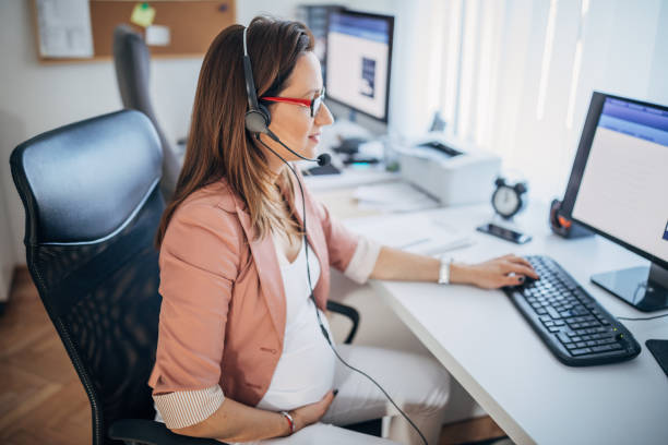 istock Pregnant woman working at the office 1188684257
