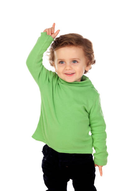 Adorable baby with green shirt  raising a hand Adorable baby with green shirt raising a hand isolated on a white background 2632 stock pictures, royalty-free photos & images