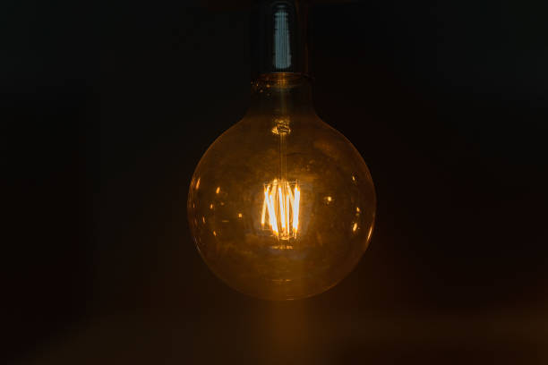 istock burning incandescent bulb on a dark background 1188690272