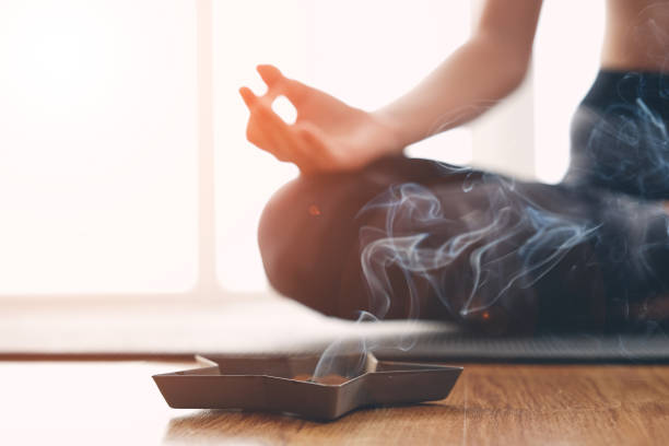 istock Woman doing yoga and burning scented sticks 1188690355