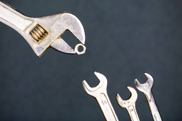 istock Adjustable wrench with nut and spanner. Imitation of feeding a chick by mom. 1188691609