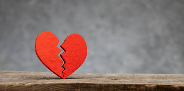 istock Broken heart. Crack in the red heart, Breaking the relationship. Grey background. 1188693756
