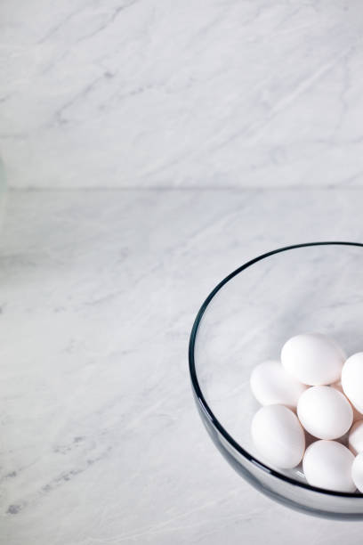 istock Whole white eggs in a glass bowl on a marble background 1188696192