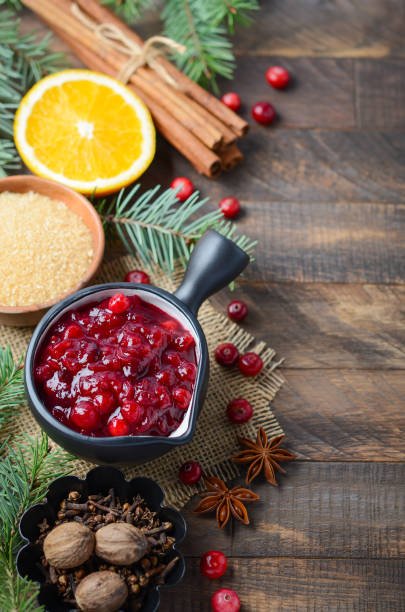 istock Cranberry sauce with ingredients on a wooden background. 1188697148
