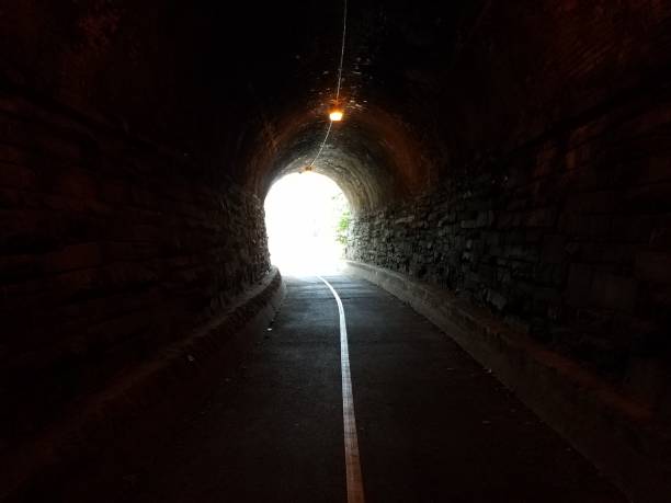 istock bright light at the end of a tunnel with trail and bricks 1188698999