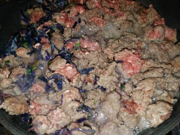beef and cabbage cooking in frying pan