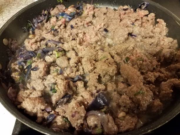 beef and cabbage cooking in frying pan