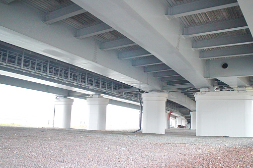 car parking under a flyover on a cloudy day