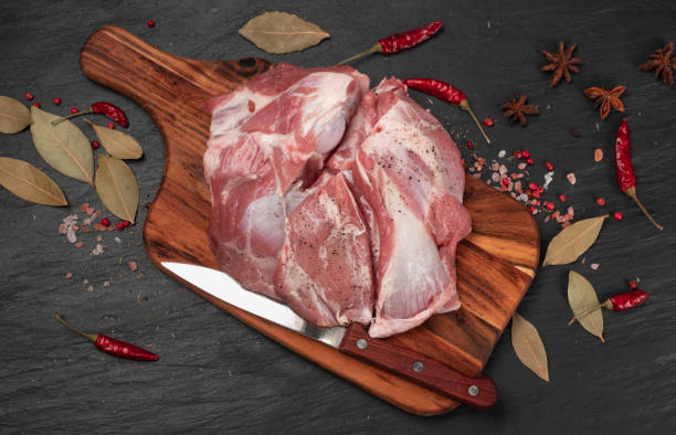 Fresh raw beef steak on black stone background
