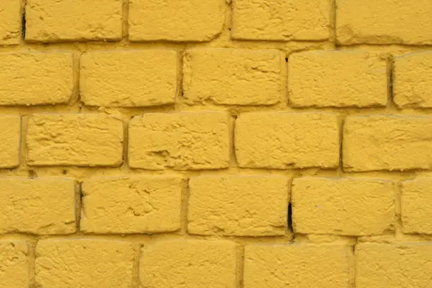 Yellow brick plastered wall for background.