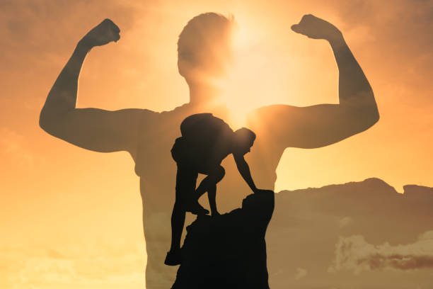 istock Man climbing up mountain, feeling strong and powerful. 1188704307