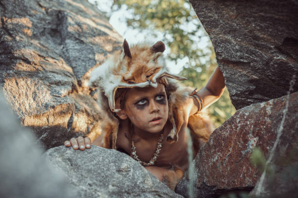 istock Caveman, manly boy hunting outdoors. Ancient warrior portrait 1188704310