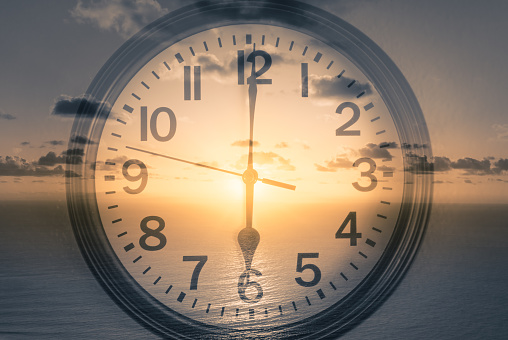 Double Exposure Image Of Clock Against Sunrise Background Stock Photo -  Download Image Now - iStock