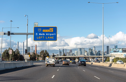 View through a vehicle windshield of the M1 (Monash) Freeway and the Melbourne city skyline in Melbourne, Australia. The entire stretch of the Monash Freeway bears the designation M1