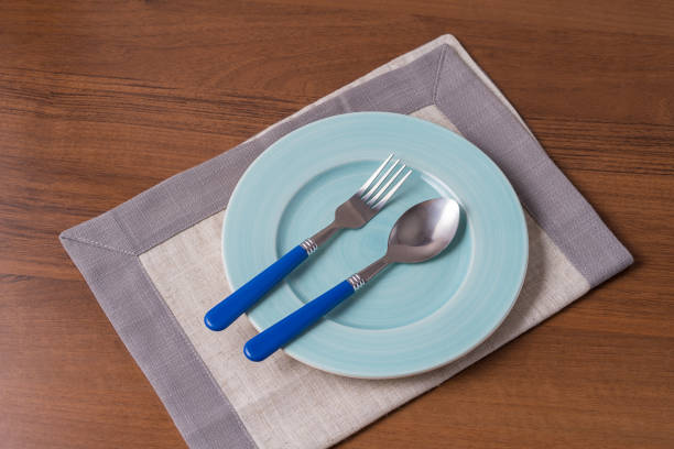 istock Food background with empty plate, spoon, fork and napkin, flat lay. 1188708228