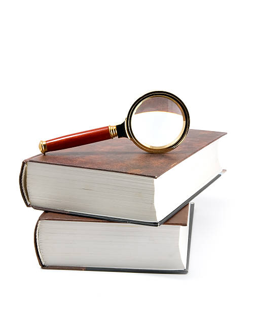 istock Magnifying glass on books. 118871195