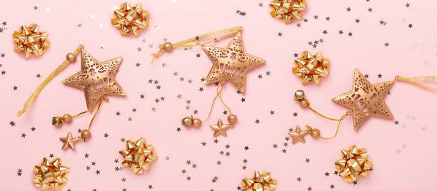 istock Christmas flat lay composition. Gold decoration on pink background. Horizontal banner 1188712717