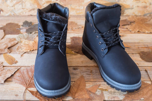 istock Winter boots at wood background 1188713038