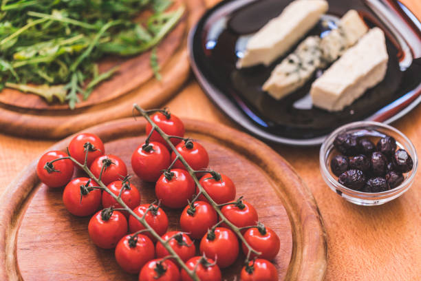 Cherry tomatoes at wooden plate, close-up