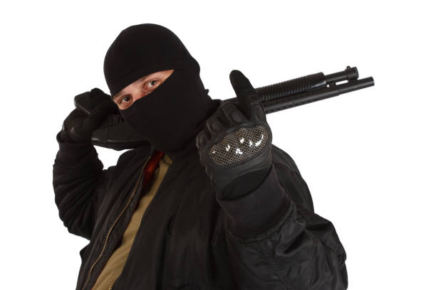 istock mobster in black mask with shotgun 1188713655
