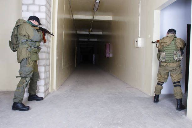 istock guerillas with AK-47 rifle inside the building 1188714700