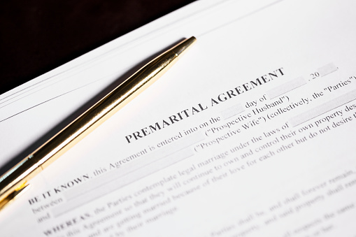 Close up of a generic premarital agreement with a pen.