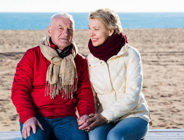 istock Mature couple sitting by sea 1188715684