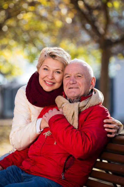 istock Mature couple sitting in park 1188715687