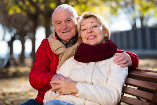istock Mature couple sitting in park 1188715693