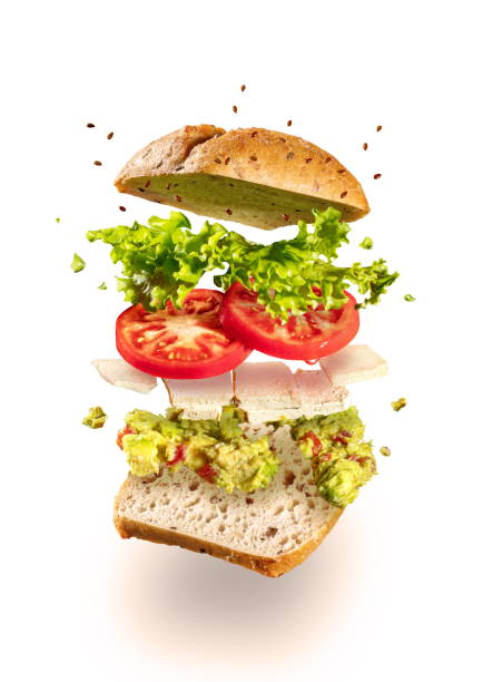 explodiertevegetarisches sandwich mit guacamole und tofu auf weiß - burger isolated lettuce tomato stock-fotos und bilder