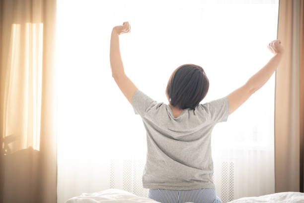 istock Woman stretching in bed in the morning 1188720246