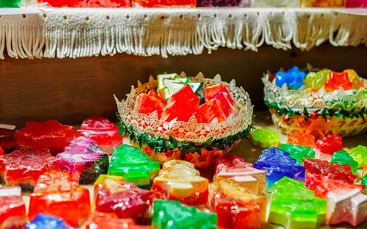 Handmade soaps for sale on stall at Christmas market in Riga, Latvia. Europe in winter. Street Xmas and holiday fair. Advent Decoration and Stalls with Crafts Items on Bazaar
