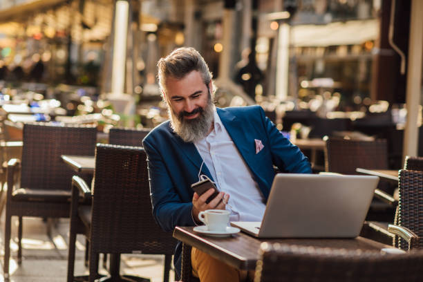istock Mature businessman podcasting at the cafe 1188728366