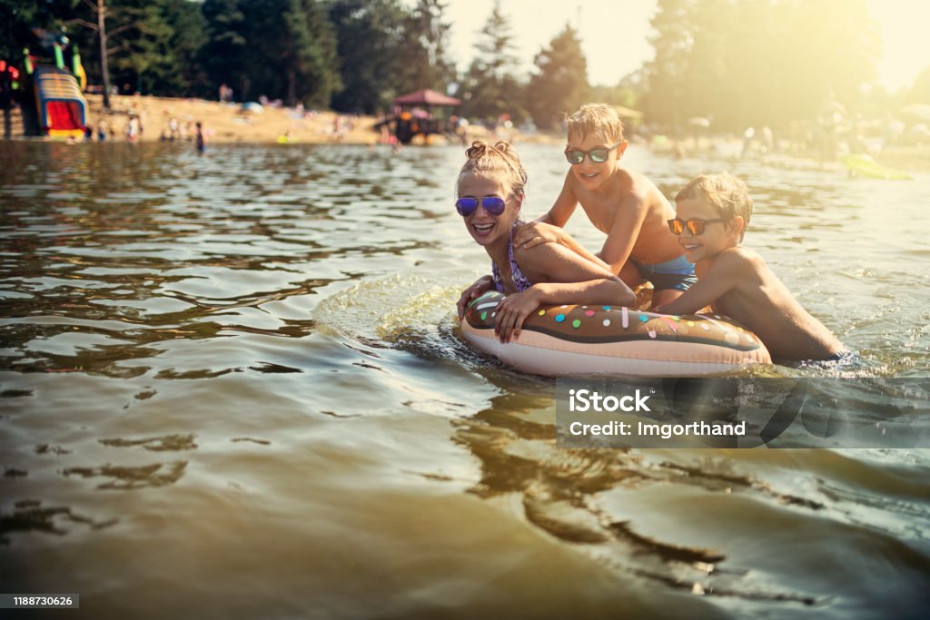 Kids enjoying playing in lake Kids are splashing and having fun on swim ring floating on the lake. Kids are laughing and having fun.
Nikon D810 Lake Stock Photo