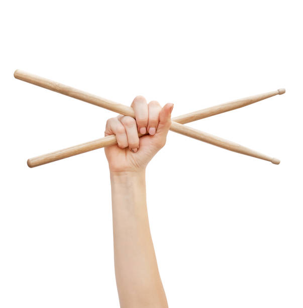 Woman's hand holding drum sticks isolated on white background. Woman's hand holding drum sticks isolated on white background. drummer hands stock pictures, royalty-free photos & images