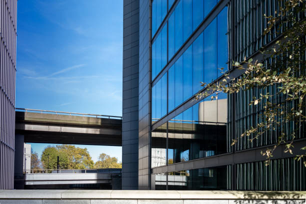 istock modern building reflection glass cladding and concrete overpass symetry in mirror view tree in foreground 1188739319