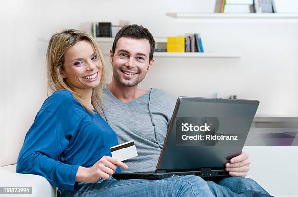 Smiling Couple Making Shopping Online Stock Photo - Download Image Now - 20-29 Years, Adult, Beautiful People