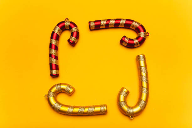istock Golden and red Christmas decorations on a yellow background. 1188745111