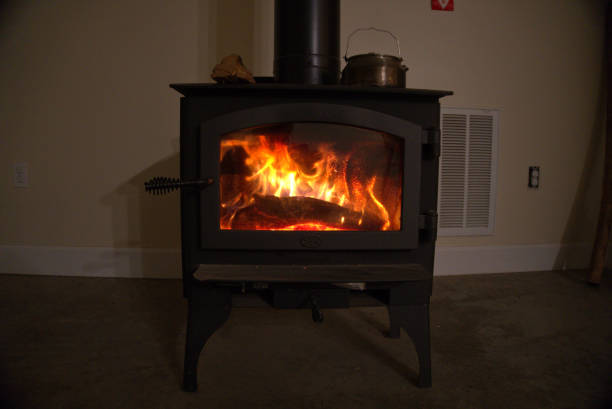 Wood stove burning inside.  Alternative heat source and energy source. stock photo