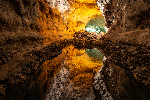 The green cave in Lanzarote. Reflection in water making it look like a giant cavern.