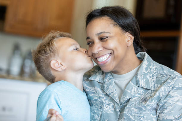 istock Elementary age son kisses soldier mother on cheek 1188759416
