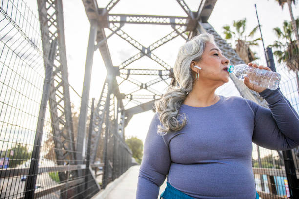 istock Senior Mexican Woman Drinking Water 1188759654