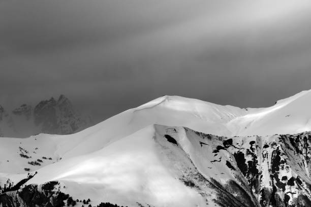 istock Sunlight mountains with snow cornice and trace from avalanche before blizzard 1188759819
