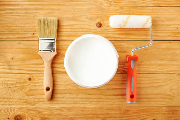 istock Painting roller, brush and can with white paint. 1188760067