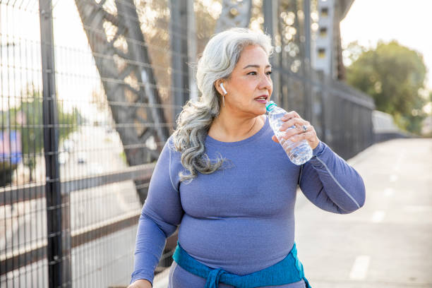 istock Senior Mexican Woman Drinking Water 1188761817