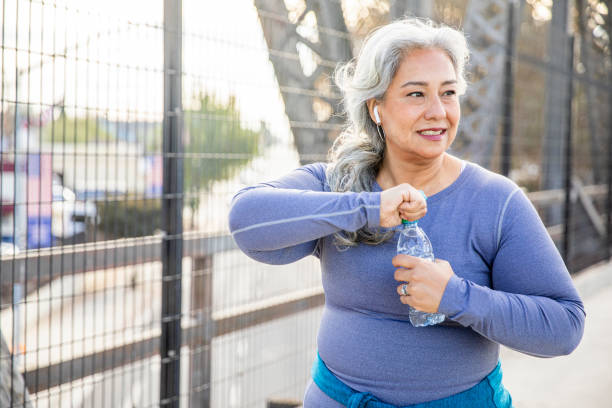 istock Senior Mexican Woman Drinking Water 1188762538